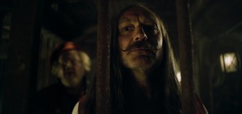 Movie still from “Peter Pan & Wendy” (2023), directed by David Lowery – A person with long hair and a mustache; Close Up shot, Low angle