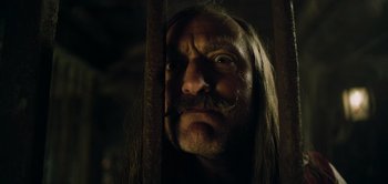 Movie still from “Peter Pan & Wendy” (2023), directed by David Lowery – A person with a beard and a mustache; Close Up shot, Low angle