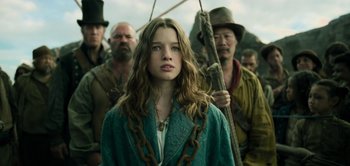 Movie still from “Peter Pan & Wendy” (2023), directed by David Lowery – A woman in chains standing in front of a group of men; Close Up shot, Low angle
