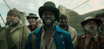 Movie still from “Peter Pan & Wendy” (2023), directed by David Lowery – A group of men standing next to each other; Medium shot, Low angle