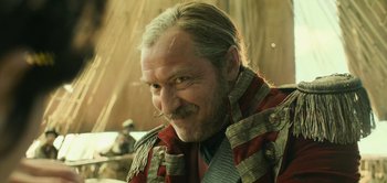 Movie still from “Peter Pan & Wendy” (2023), directed by David Lowery – A person with a beard and mustache; Close Up shot, Low angle