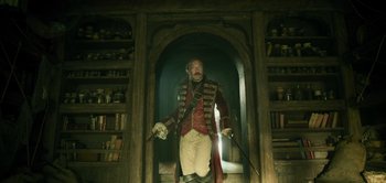 Movie still from “Peter Pan & Wendy” (2023), directed by David Lowery – A man dressed in a red and white coat and white pants; Medium shot, Low angle