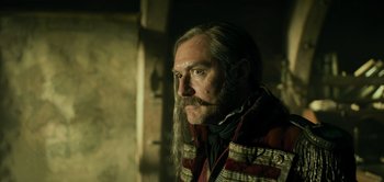 Movie still from “Peter Pan & Wendy” (2023), directed by David Lowery – A person with long grey hair; Close Up shot, Low angle