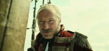 Movie still from “Peter Pan & Wendy” (2023), directed by David Lowery – A person with a mustache wearing a uniform; Close Up shot, Low angle