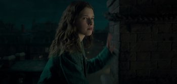 Movie still from “Peter Pan & Wendy” (2023), directed by David Lowery – A young girl standing next to a brick wall; Close Up shot, Low angle