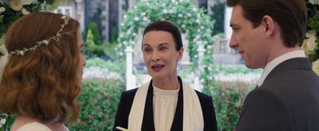 Movie still from “Peter Rabbit 2: The Runaway” (2021), directed by Will Gluck – A woman in a black and white outfit holding a pencil; Medium shot, Over the shoulder angle