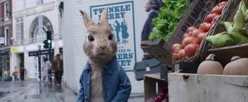 Movie still from “Peter Rabbit 2: The Runaway” (2021), directed by Will Gluck – A rabbit wearing a blue jean jacket standing in front of vegetables; Medium shot, Over the shoulder angle