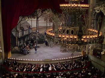 Movie still from “Phantom of the Opera” (1943), directed by Arthur Lubin – An orchestra is playing in a large theater; Extreme Wide shot, High angle