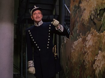 Movie still from “Phantom of the Opera” (1943), directed by Arthur Lubin – A man dressed in a uniform and holding a cane; Medium shot, Low angle