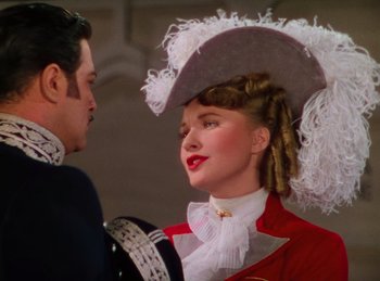 Movie still from “Phantom of the Opera” (1943), directed by Arthur Lubin – A man and a woman wearing a hat; Close Up shot, Low angle