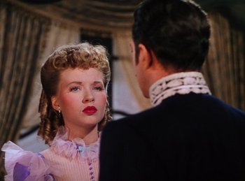 Movie still from “Phantom of the Opera” (1943), directed by Arthur Lubin – A man and a woman standing next to each other; Close Up shot, Over the shoulder angle