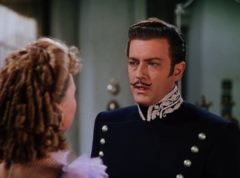 Movie still from “Phantom of the Opera” (1943), directed by Arthur Lubin – A man with a mustache is talking to a woman in front of a mirror; Close Up shot, Over the shoulder angle