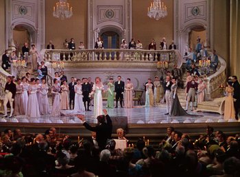Movie still from “Phantom of the Opera” (1943), directed by Arthur Lubin – A large group of people are gathered around a stage; Extreme Wide shot, High angle