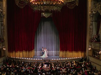 Movie still from “Phantom of the Opera” (1943), directed by Arthur Lubin – A bride and groom are dancing in front of an audience; Extreme Wide shot, High angle