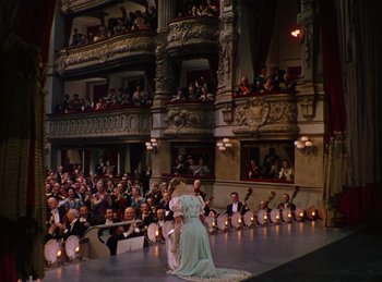 Movie still from “Phantom of the Opera” (1943), directed by Arthur Lubin – A woman in a white dress is on the stage; Extreme Wide shot, High angle