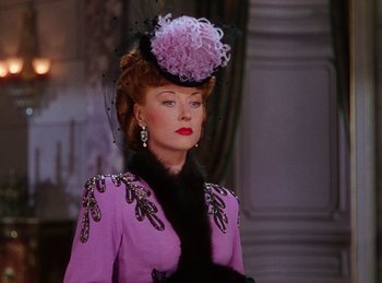 Movie still from “Phantom of the Opera” (1943), directed by Arthur Lubin – A person wearing a hat and a dress; Medium shot, Over the shoulder angle