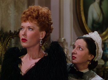 Movie still from “Phantom of the Opera” (1943), directed by Arthur Lubin – A woman in a black dress next to another woman in a black dress; Close Up shot, Over the shoulder angle