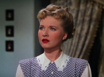 Movie still from “Phantom of the Opera” (1943), directed by Arthur Lubin – A woman in a polka dot shirt and a white and blue polka dot dress; Close Up shot, High angle