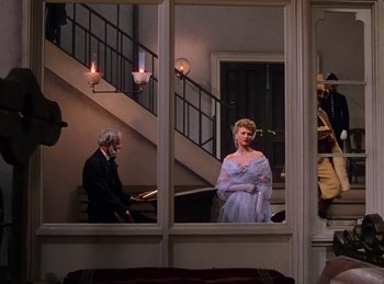 Movie still from “Phantom of the Opera” (1943), directed by Arthur Lubin – A man and a woman are standing in front of a window; Wide shot, Over the shoulder angle