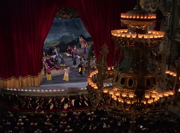 Movie still from “Phantom of the Opera” (1943), directed by Arthur Lubin – A stage with a fountain and people in the background; Extreme Wide shot, High angle