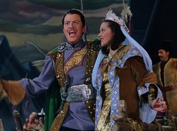 Movie still from “Phantom of the Opera” (1943), directed by Arthur Lubin – A man and a woman dressed in costumes; Medium shot, Low angle