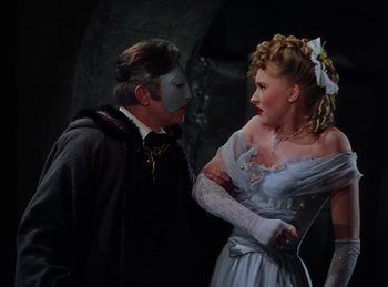 Movie still from “Phantom of the Opera” (1943), directed by Arthur Lubin – A man and a woman dressed up in costumes; Close Up shot, Over the shoulder angle