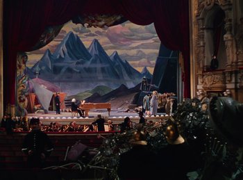 Movie still from “Phantom of the Opera” (1943), directed by Arthur Lubin – A painting of a stage with a piano in the middle of the stage; Extreme Wide shot, High angle