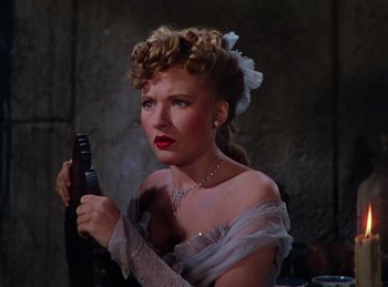 Movie still from “Phantom of the Opera” (1943), directed by Arthur Lubin – A woman in a white dress holding a gun in her hand; Close Up shot, High angle