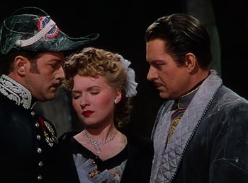 Movie still from “Phantom of the Opera” (1943), directed by Arthur Lubin – Two men and a woman standing next to each other; Medium shot, Over the shoulder angle
