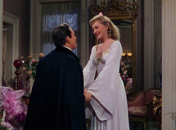 Movie still from “Phantom of the Opera” (1943), directed by Arthur Lubin – A man and a woman are holding each other's hands; Medium shot, Low angle