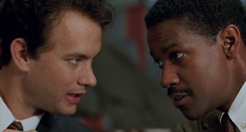 Movie still from “Philadelphia” (1993), directed by Jonathan Demme – Two men talking to each other in front of each other; Close Up shot, Over the shoulder angle