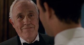 Movie still from “Philadelphia” (1993), directed by Jonathan Demme – An older man in a tuxedo looking at a younger man in a suit; Close Up shot, Over the shoulder angle