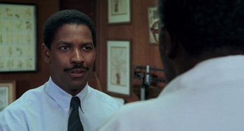 Movie still from “Philadelphia” (1993), directed by Jonathan Demme – A man wearing a white dress shirt and a tie; Close Up shot, Over the shoulder angle