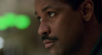 Movie still from “Philadelphia” (1993), directed by Jonathan Demme – A man's face with green light in the background; Close Up shot, Low angle