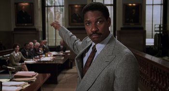 Movie still from “Philadelphia” (1993), directed by Jonathan Demme – A man in a suit and tie pointing at the camera; Medium shot, Low angle