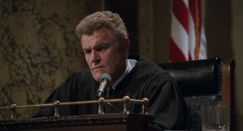 Movie still from “Philadelphia” (1993), directed by Jonathan Demme – A man wearing a robe and sitting at a table; Close Up shot, Low angle