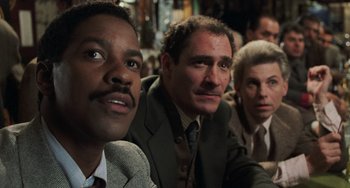 Movie still from “Philadelphia” (1993), directed by Jonathan Demme – A group of men in suits and ties sitting next to each other; Close Up shot, Low angle