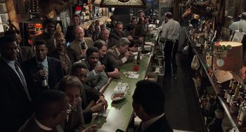 Movie still from “Philadelphia” (1993), directed by Jonathan Demme – A group of people sitting at a long table; Wide shot, High angle