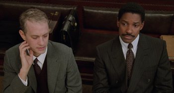 Movie still from “Philadelphia” (1993), directed by Jonathan Demme – Two men in suits sitting next to each other in a room; Medium shot, High angle