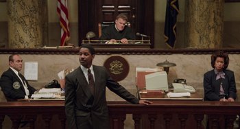 Movie still from “Philadelphia” (1993), directed by Jonathan Demme – A man standing in front of a judge in a courtroom; Wide shot, Low angle