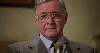 Movie still from “Philadelphia” (1993), directed by Jonathan Demme – An older man wearing glasses and a suit and tie; Close Up shot, Low angle