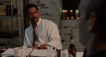 Movie still from “Philadelphia” (1993), directed by Jonathan Demme – A man sitting at a table in front of a bottle of beer; Close Up shot, Over the shoulder angle