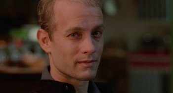 Movie still from “Philadelphia” (1993), directed by Jonathan Demme – A man's face in a black shirt; Close Up shot, Low angle