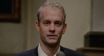 Movie still from “Philadelphia” (1993), directed by Jonathan Demme – A person wearing a suit and tie; Close Up shot, Low angle