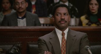 Movie still from “Philadelphia” (1993), directed by Jonathan Demme – A man in a suit and tie sitting in a court room; Close Up shot, Low angle