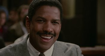 Movie still from “Philadelphia” (1993), directed by Jonathan Demme – A person wearing a suit and tie smiling; Close Up shot, Low angle