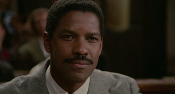 Movie still from “Philadelphia” (1993), directed by Jonathan Demme – A person wearing a suit and tie; Close Up shot, Low angle