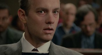 Movie still from “Philadelphia” (1993), directed by Jonathan Demme – A person wearing a suit and tie; Close Up shot, Over the shoulder angle