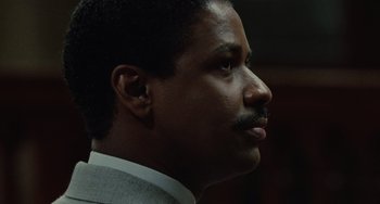 Movie still from “Philadelphia” (1993), directed by Jonathan Demme – A person wearing a suit and tie; Close Up shot, Low angle