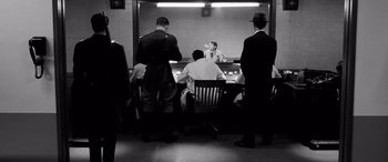 Movie still from “Pineapple Express” (2008), directed by David Gordon Green – A group of men sitting at a table in front of a mirror; Wide shot, Over the shoulder angle